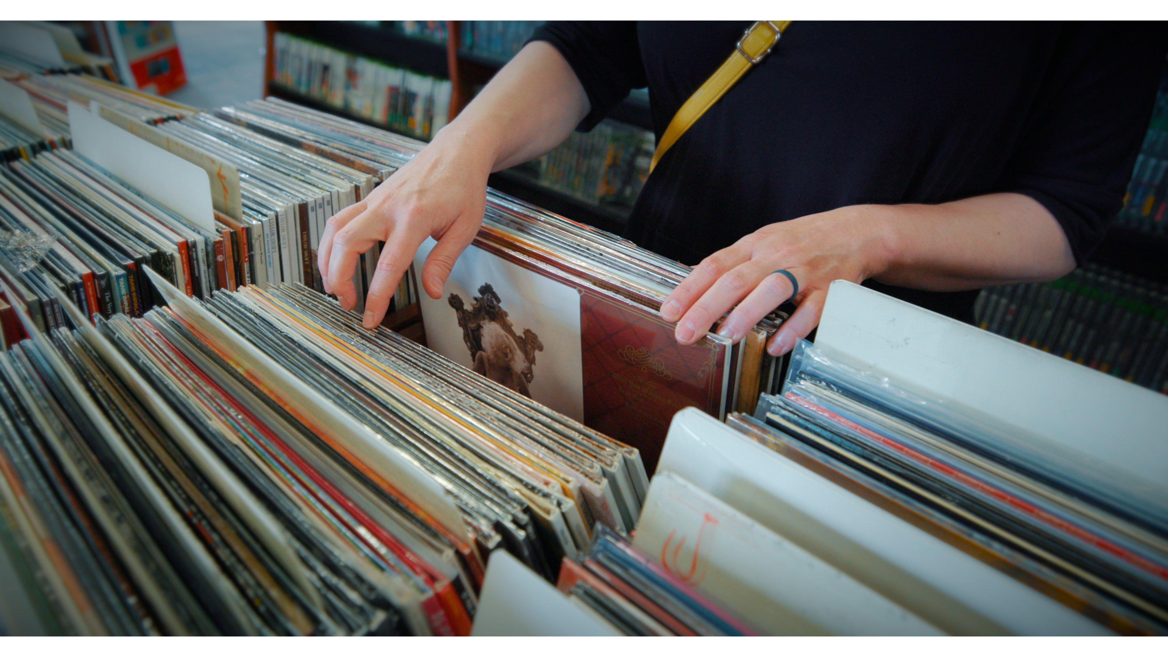 A customer sorting through a vinyl bin at a FieldStack record store client