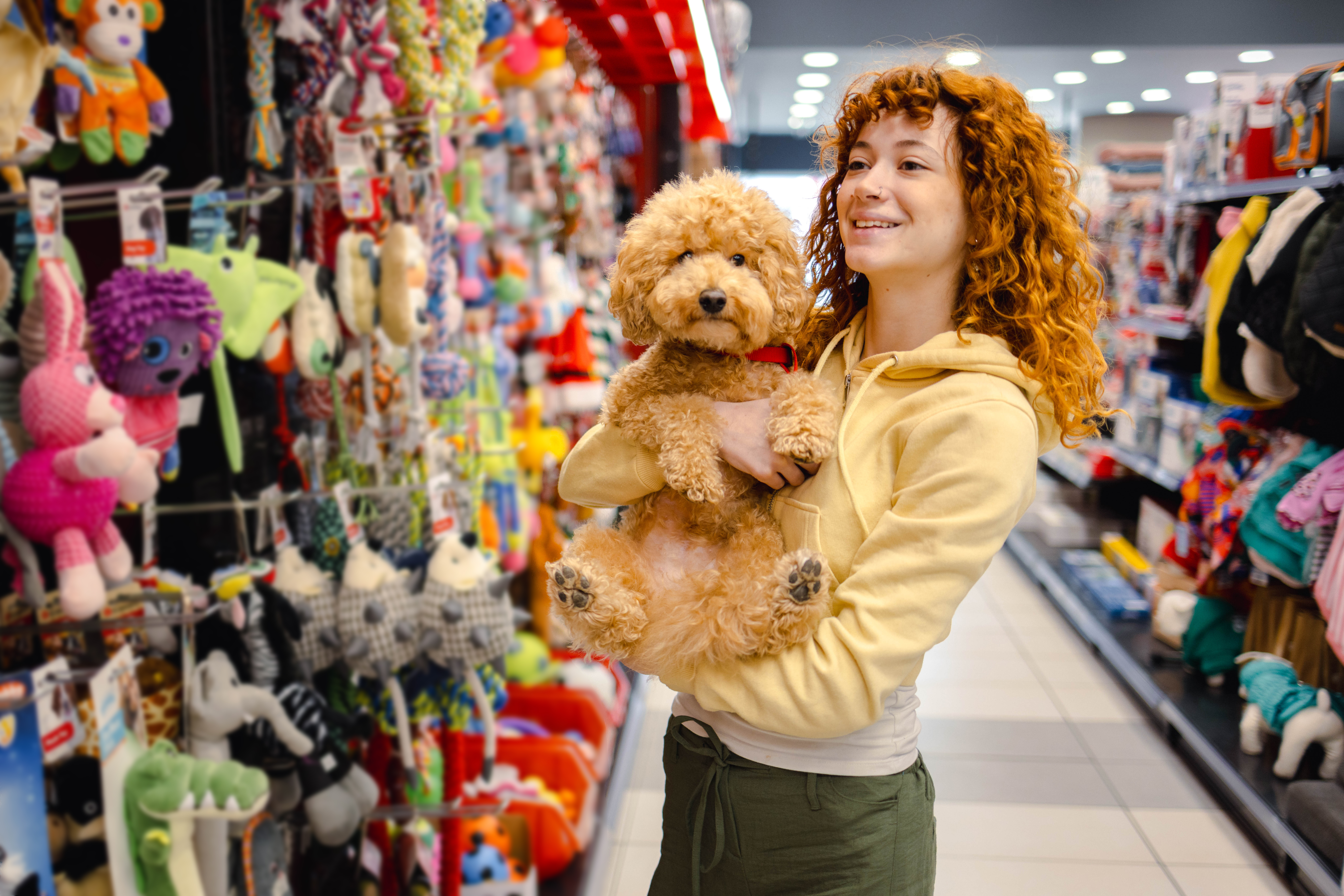 Woman with dog in a pet store aisle